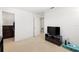 Clean bedroom with carpeting, an exterior door, and a small entertainment center at 5909 Canton S St, St Petersburg, FL 33712