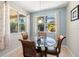 Cozy breakfast nook with a glass-top table and outdoor views from multiple windows at 5909 Canton S St, St Petersburg, FL 33712