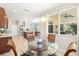 Sunlit breakfast nook with a glass table, views into the kitchen, and outside views from the multiple windows at 5909 Canton S St, St Petersburg, FL 33712