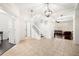 Bright foyer with tile flooring, a staircase, and views into the living room at 5909 Canton S St, St Petersburg, FL 33712
