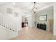 Light-filled foyer featuring tile flooring, a staircase, and an accent wall with decorative items at 5909 Canton S St, St Petersburg, FL 33712