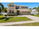 Inviting two-story home with a manicured lawn, stone accents, and a spacious two-car garage at 5909 Canton S St, St Petersburg, FL 33712