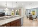 Bright kitchen view showcasing bar seating, stainless steel appliances, and a view into the breakfast nook at 5909 Canton S St, St Petersburg, FL 33712
