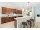 Bright kitchen featuring stainless steel appliances, dark wood cabinetry, tile flooring, and barstool seating at 5909 Canton S St, St Petersburg, FL 33712