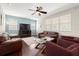 Spacious living room with hardwood floors, large windows, a ceiling fan, and comfortable seating at 5909 Canton S St, St Petersburg, FL 33712