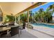 Outdoor patio with ceiling fan, table, foosball and views of the pool and lush greenery at 5909 Canton S St, St Petersburg, FL 33712