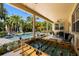 Covered patio with a foosball table and views of the lush tropical backyard and pool at 5909 Canton S St, St Petersburg, FL 33712