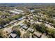 This aerial shot showcases a community with lush greenery, a tranquil pond, and well-maintained streets, perfect for peaceful living at 620 11Th Pl, Safety Harbor, FL 34695