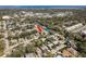 Aerial view of a charming neighborhood, showcasing the home's location with lush greenery and water in the distance at 620 11Th Pl, Safety Harbor, FL 34695