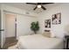 Comfortable bedroom featuring stylish decor, a ceiling fan, and an en-suite bathroom at 620 11Th Pl, Safety Harbor, FL 34695