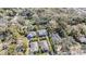 Aerial view showcases a neighborhood with mature trees surrounding the homes and their well-manicured lawns at 6911 N 19Th St, Tampa, FL 33610