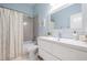 Well-lit bathroom with a large mirror, vanity, and shower with patterned tile accent at 6911 N 19Th St, Tampa, FL 33610