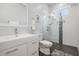 Bright bathroom with a glass shower featuring stylish tile accents, modern fixtures, and a vanity at 6911 N 19Th St, Tampa, FL 33610