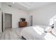 Open bedroom showcasing a view from the bed, light colored wood floors and neutral decor at 6911 N 19Th St, Tampa, FL 33610