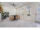 Bright dining room with a round table, modern light fixture, and white flooring at 6911 N 19Th St, Tampa, FL 33610