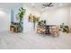 Bright dining room with a round table, modern light fixture, and white flooring at 6911 N 19Th St, Tampa, FL 33610