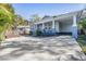 Home with a cozy porch, convenient carport, and well-maintained landscaping at 6911 N 19Th St, Tampa, FL 33610