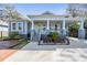 Charming home featuring a cozy front porch, carport, and meticulous landscaping at 6911 N 19Th St, Tampa, FL 33610