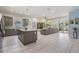 Spacious open-concept kitchen features stainless steel appliances, gray cabinetry, and a large granite island at 6911 N 19Th St, Tampa, FL 33610
