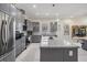 Stylish kitchen boasts stainless steel appliances, gray cabinets, granite countertops, and a functional center island at 6911 N 19Th St, Tampa, FL 33610