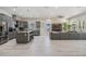 Bright kitchen featuring stainless steel appliances, gray cabinets, a granite island, and an open layout at 6911 N 19Th St, Tampa, FL 33610