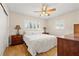 Bedroom with hardwood floors, a ceiling fan, and windows with plantation shutters at 8467 8Th N Way, St Petersburg, FL 33702