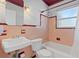 Bathroom features pink tile, bathtub with shower and a sink at 930 40Th Ne Ave, St Petersburg, FL 33703