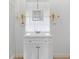 Bright bathroom features a vanity with cabinet storage, decorative light fixtures and luxury gold accents at 930 40Th Ne Ave, St Petersburg, FL 33703