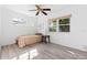 Cozy bedroom with light wood floors, neutral walls, and natural light from the exterior windows at 930 40Th Ne Ave, St Petersburg, FL 33703