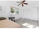 Bedroom with light wood floors, neutral paint, large window, and a closet for storage at 930 40Th Ne Ave, St Petersburg, FL 33703