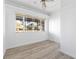 Bright bedroom boasts wood-look floors and a large window offering ample natural light at 930 40Th Ne Ave, St Petersburg, FL 33703