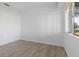 Bright bedroom featuring light-colored laminate flooring and freshly painted white walls at 930 40Th Ne Ave, St Petersburg, FL 33703