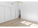 Bedroom featuring light wood floors, neutral paint, closet, and access to a bathroom at 930 40Th Ne Ave, St Petersburg, FL 33703