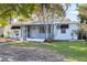 Inviting single-story home with light blue exterior, screened porch, and well-kept front lawn at 930 40Th Ne Ave, St Petersburg, FL 33703