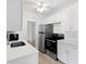 Bright kitchen with white cabinets, stainless steel appliances, and modern countertops at 930 40Th Ne Ave, St Petersburg, FL 33703