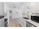 Modern kitchen featuring stainless steel appliances, white cabinetry, and wood-look flooring at 930 40Th Ne Ave, St Petersburg, FL 33703