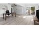 Open-concept living room with sliding glass doors and sleek vinyl flooring, bathed in natural light at 930 40Th Ne Ave, St Petersburg, FL 33703