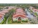 Scenic aerial view of condo buildings with red tile roofs nestled among mature trees at 9481 Highland Oak Dr # 706, Tampa, FL 33647