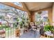 Cozy balcony filled with potted plants, comfortable seating, and natural light, creating a serene outdoor space at 9481 Highland Oak Dr # 706, Tampa, FL 33647