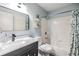 Modern bathroom featuring a vanity with granite countertops, shower and tub combo, and stylish decorations at 9481 Highland Oak Dr # 706, Tampa, FL 33647