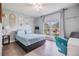 Bedroom with ample natural light, a platform bed, and hardwood floors at 9481 Highland Oak Dr # 706, Tampa, FL 33647