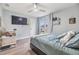 Bedroom with ample natural light, mounted TV, and hardwood floors at 9481 Highland Oak Dr # 706, Tampa, FL 33647