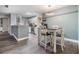 Eat in kitchen features a modern light fixture, gray walls, white trim, and view to the kitchen at 9481 Highland Oak Dr # 706, Tampa, FL 33647