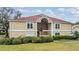 Well-maintained condo building with a red roof, featuring manicured landscaping, providing a charming curb appeal at 9481 Highland Oak Dr # 706, Tampa, FL 33647