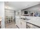 Spacious kitchen features white cabinets, granite countertops, stainless appliances with a view to the dining room at 9481 Highland Oak Dr # 706, Tampa, FL 33647