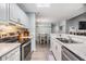 Charming kitchen features white cabinets, granite countertops, and stainless steel appliances with eat in kitchen at 9481 Highland Oak Dr # 706, Tampa, FL 33647