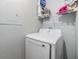 Neat laundry area features a white Samsung dryer and a shelf for storing laundry essentials and household items at 9481 Highland Oak Dr # 706, Tampa, FL 33647
