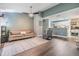 Inviting living room with modern gray paint, wood floors, ceiling fan, and view into the kitchen at 9481 Highland Oak Dr # 706, Tampa, FL 33647