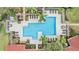 Aerial view of a community pool area with lounge chairs, tables, and lush landscaping, perfect for relaxation at 9481 Highland Oak Dr # 706, Tampa, FL 33647