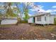 Backyard with a rustic shed and a charming home with a metal roof at 105 E Calhoun St, Plant City, FL 33563